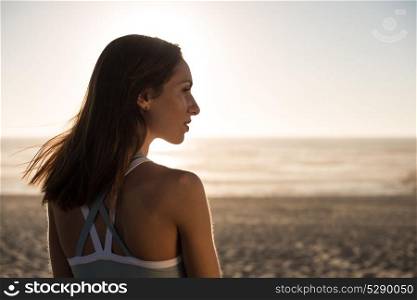Portrait of woman enjoying beautiful sunset on the beach