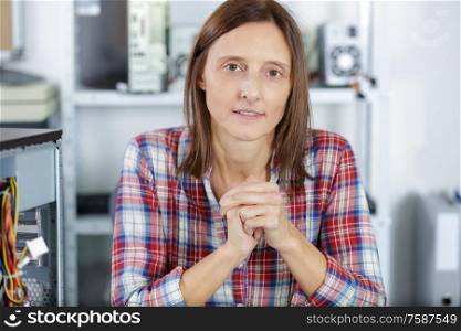 portrait of woman fixing a pc
