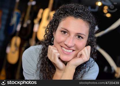 Portrait of woman, guitars in background