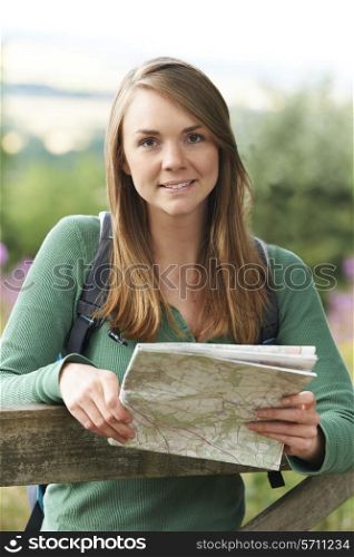 Portrait Of Woman Hiking In Countryside Looking At Map