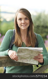 Portrait Of Woman Hiking In Countryside Looking At Map