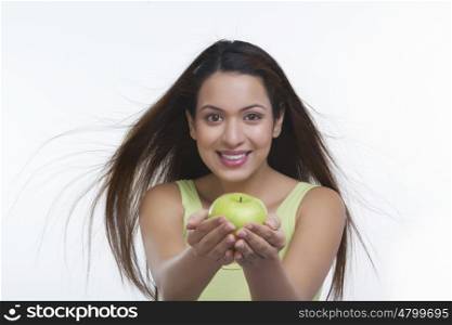 Portrait of woman holding an apple