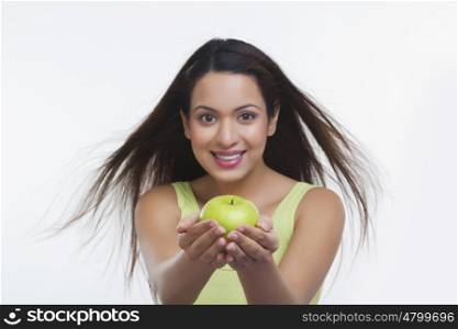 Portrait of woman holding an apple