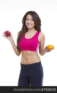 Portrait of woman holding apple and orange