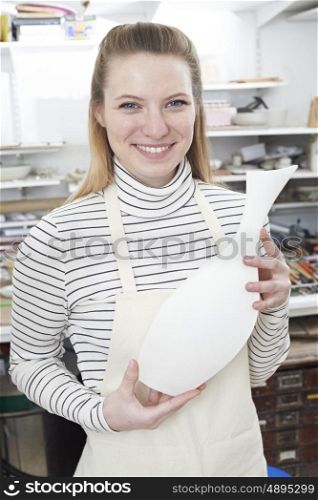 Portrait Of Woman Holding Vase In Pottery Studio