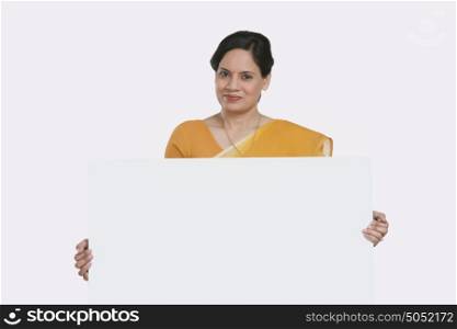 Portrait of woman holding white board