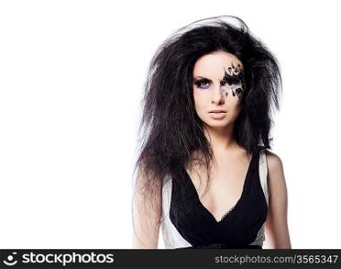 Portrait of woman in black and white dress with black hair and face art on white background