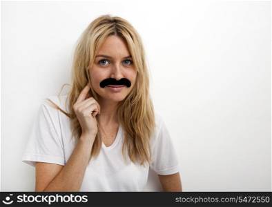 Portrait of woman in fake mustache against white background