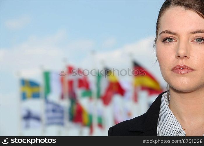 Portrait of woman in front of flags