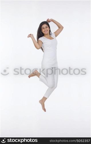 Portrait of woman jumping in the air
