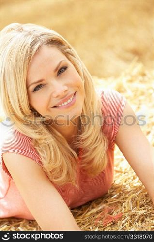 Portrait Of Woman Laying In Summer Harvested Field