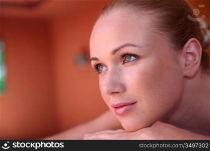 Portrait of woman laying on massage bed