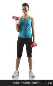 Portrait of woman lifting dumbbells isolated over white background