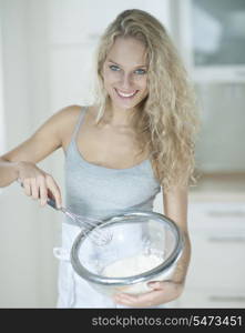 Portrait of woman mixing cookie batter in kitchen