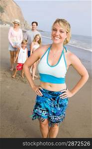 Portrait of woman on beach with family
