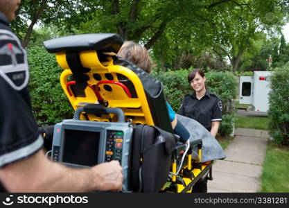 Portrait of woman on emergency medical team taking patient to hospital