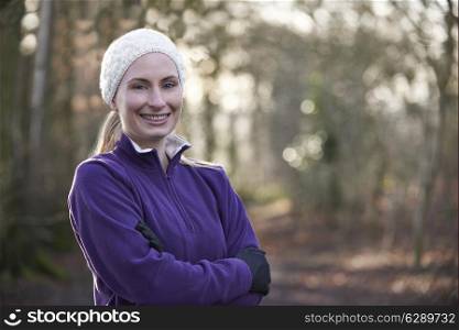 Portrait Of Woman On Winter Run Through Woodland