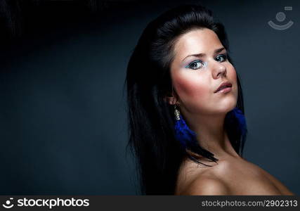 Portrait of woman over dark gray background