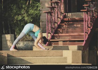portrait of woman playing yoga at home garden. portrait of woman playing yoga at home garden