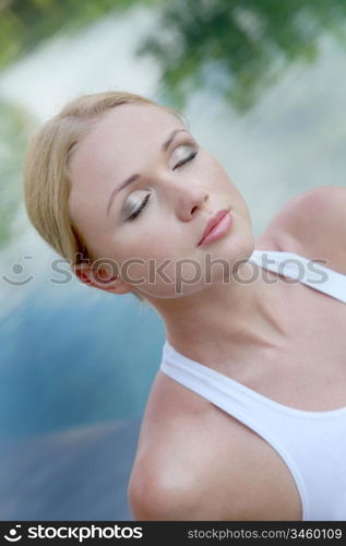 Portrait of woman relaxing on pool deck