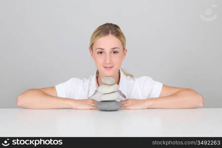 Portrait of woman set by pile of pebbles