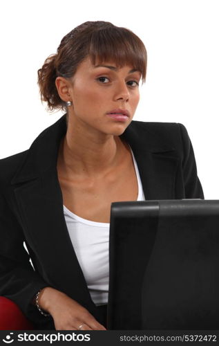 Portrait of woman sitting in front of laptop