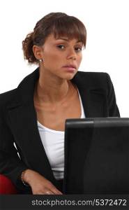 Portrait of woman sitting in front of laptop