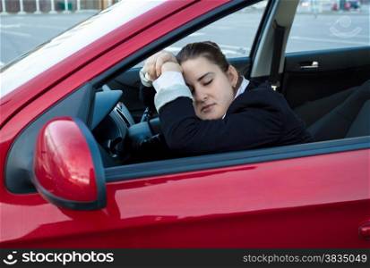 Portrait of woman sleeping in car on drivers seat