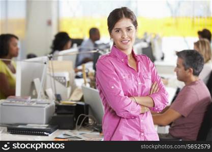 Portrait Of Woman Standing In Busy Creative Office