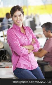 Portrait Of Woman Standing In Busy Creative Office