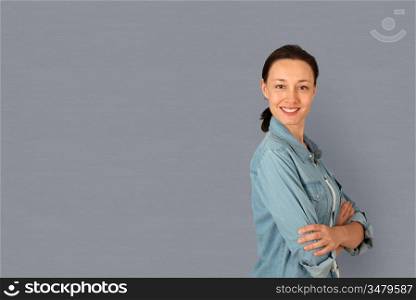 Portrait of woman standing on grey background