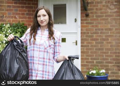 Portrait Of Woman Taking Out Garbage In Bags