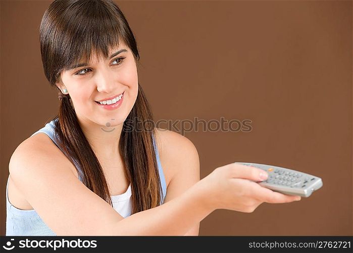 Portrait of woman teenager watch television hold remote control