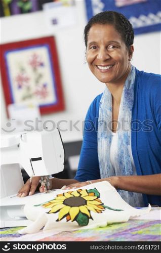 Portrait Of Woman Using Electric Sewing Machine