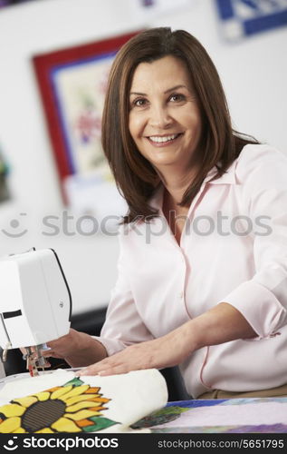 Portrait Of Woman Using Electric Sewing Machine