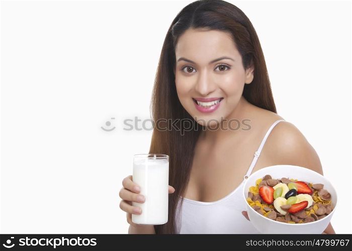 Portrait of woman with a glass of milk and cereal