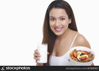 Portrait of woman with a glass of milk and cereal