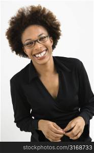 Portrait of woman with afro wearing eyeglasses against white background.