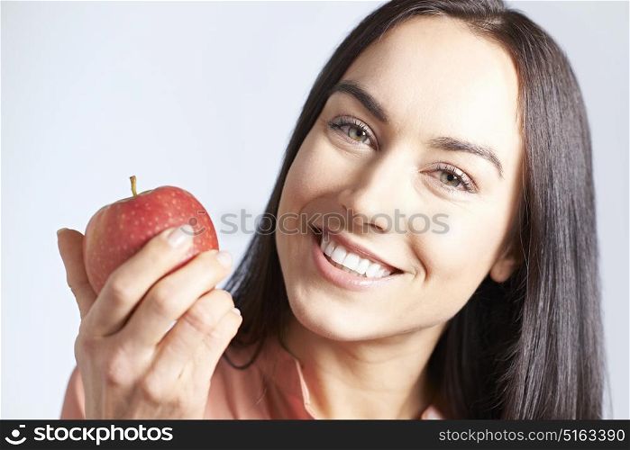 Portrait Of Woman With Beautiful Smile Holding Apple