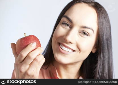 Portrait Of Woman With Beautiful Smile Holding Apple