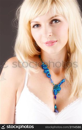Portrait of woman with blue necklace
