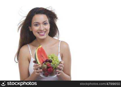 Portrait of woman with bowl of fruits
