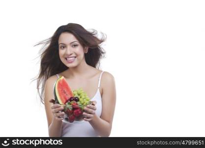 Portrait of woman with bowl of fruits