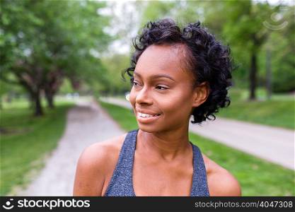 Portrait of woman with curly hair looking away smiling