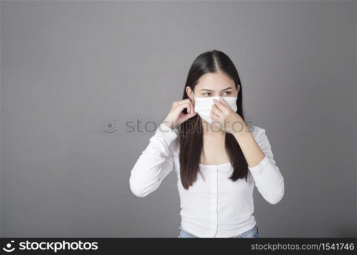 Portrait of woman with surgical mask in studio, Health care concept