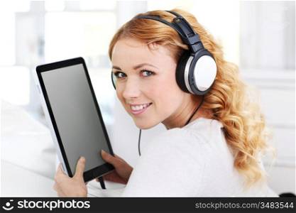 Portrait of woman with tablet and headphones