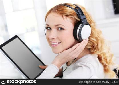 Portrait of woman with tablet and headphones