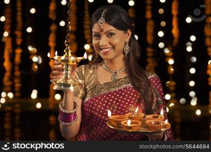 Portrait of woman with tray of diyas