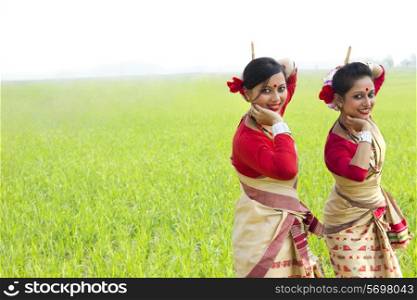Portrait of women doing Bihu dance