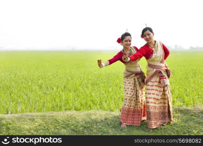 Portrait of women doing Bihu dance